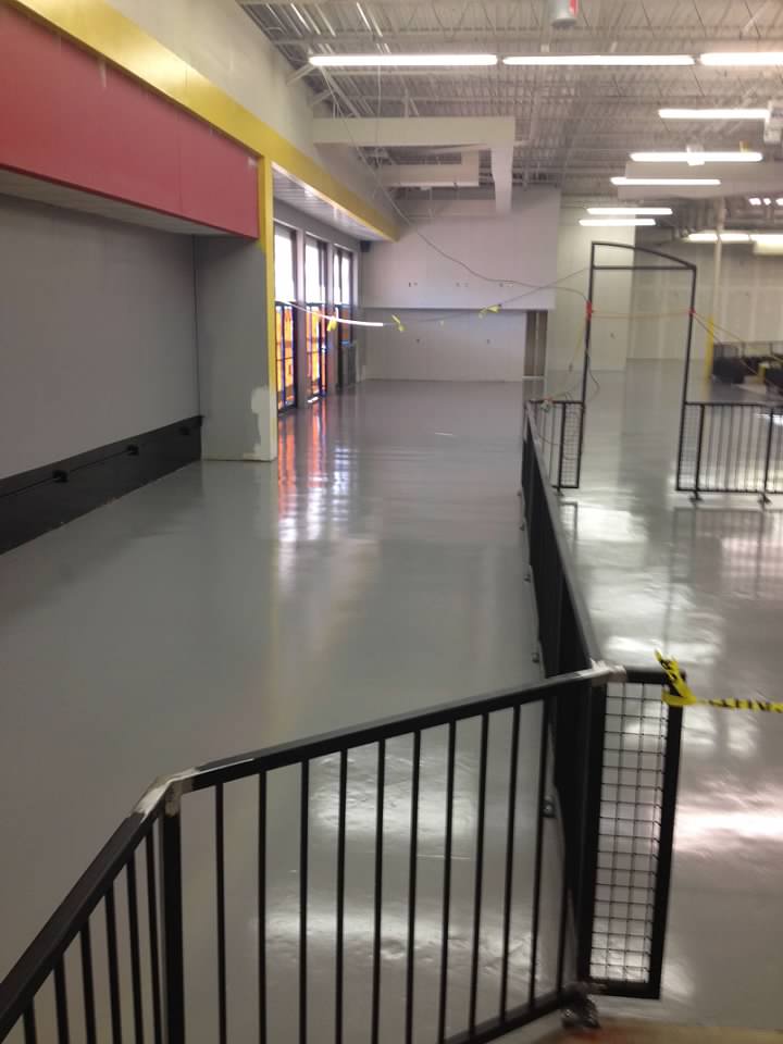 Coated floor with a fenced off area inside of it
