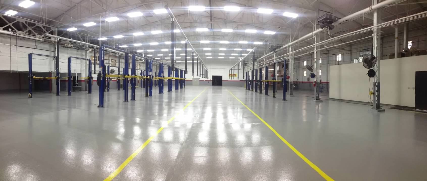 Coated floor with multiple large car jacks lined up